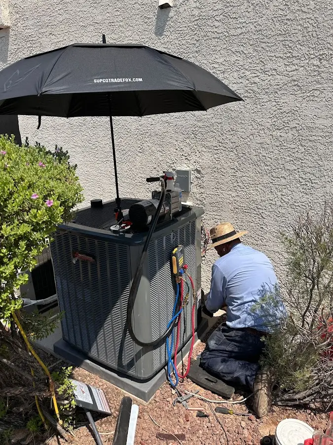 HVAC technician performing outdoor AC maintenance in Taylors
